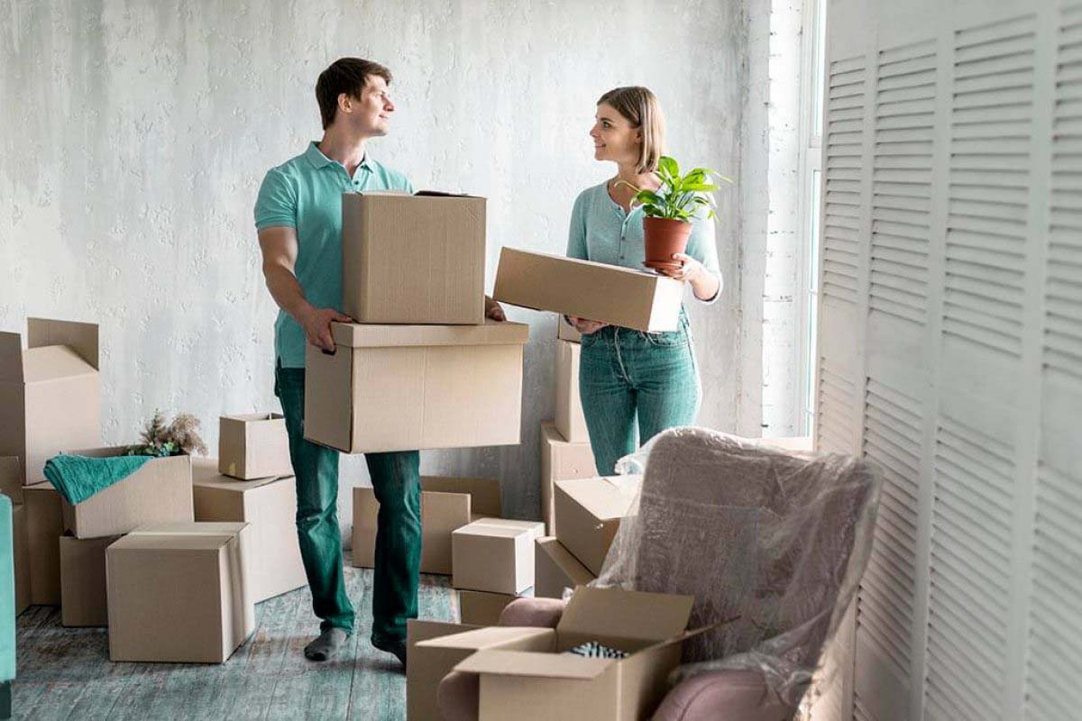 man and woman unpacking boxes